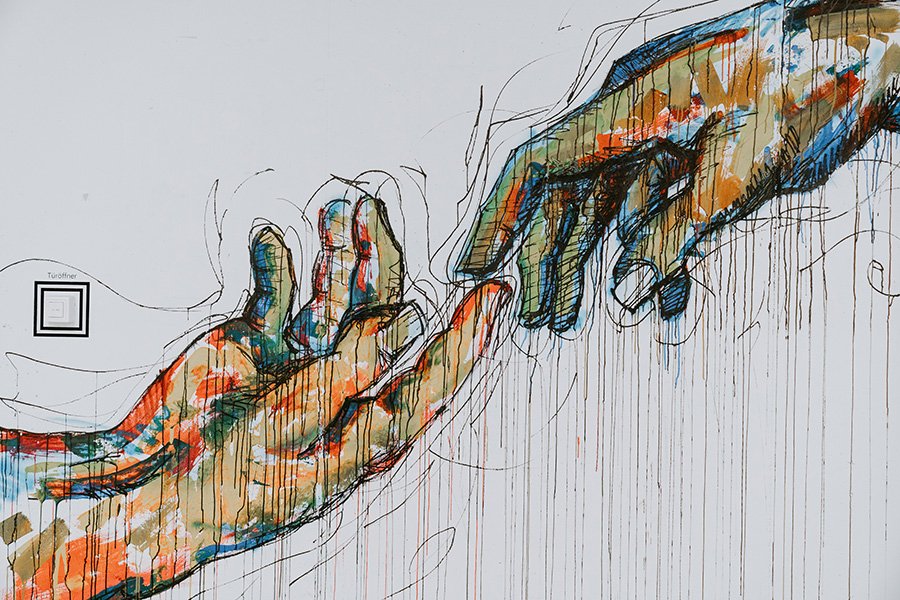 LinkedIn Profile. Showing a graffiti image of two hands reaching for connection.