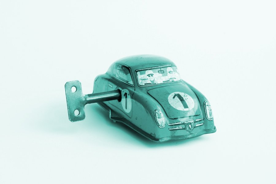 reusing content: shows a small metal wind up toy car.